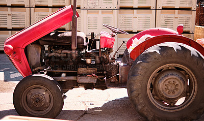 Buy stock photo Shot of a tractor parked at a farm