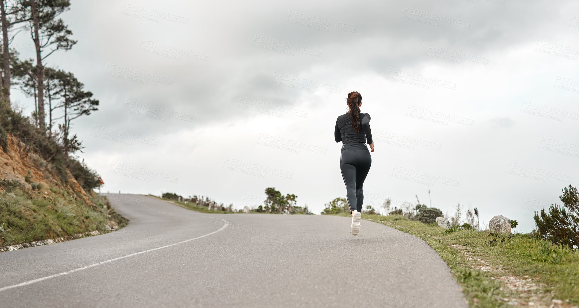 Buy stock photo Full length shot of an unrecognizable woman jogging alone outdoors