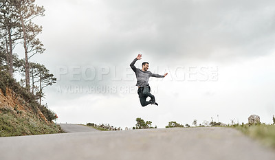 Buy stock photo Full length shot of a handsome young man jumping for joy after his morning run outdoors