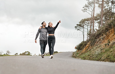 Buy stock photo Full length shot of two young athletes walking with their arms around each other after a run outdoors