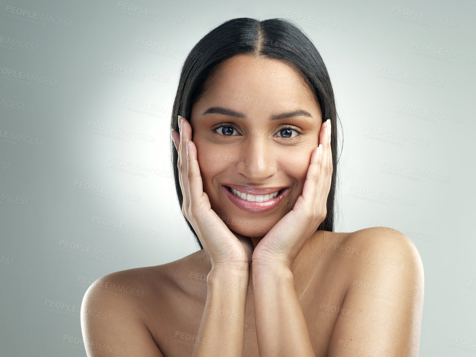 Buy stock photo Cropped shot of a beautiful young woman with flawless skin posing against a grey background