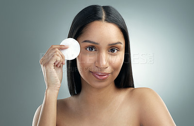 Buy stock photo Shot of a beautiful young woman holding a cotton pad against her face