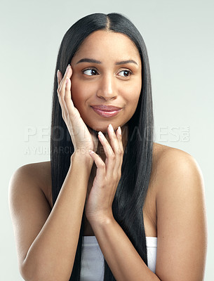 Buy stock photo Cropped shot of a beautiful young woman with flawless skin posing against a grey background