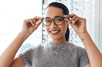 Buy stock photo Glasses, vision and treatment by satisfied woman at optometrist, smiling and confident. Portrait of carefree female buying trendy spectacles to help with blurry vision, excited about her eyeglasses 
