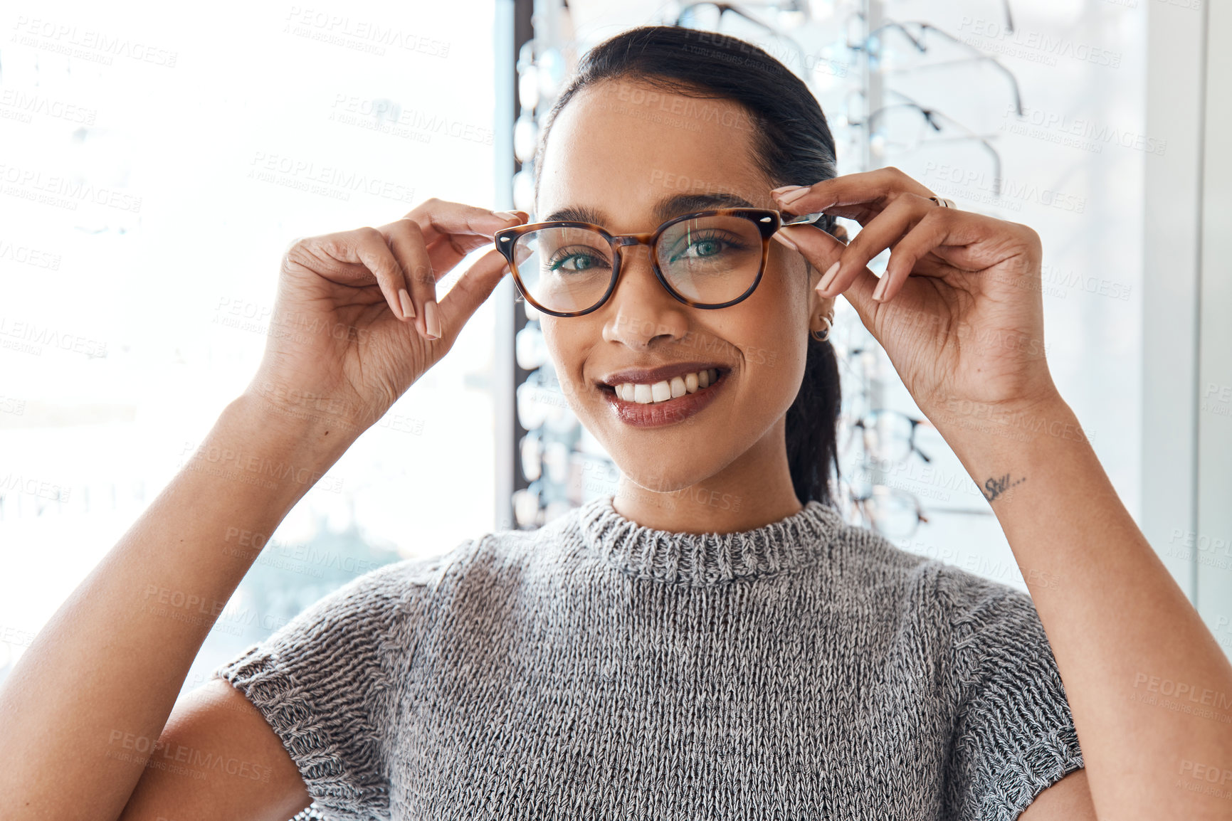Buy stock photo Glasses, vision and treatment by satisfied woman at optometrist, smiling and confident. Portrait of carefree female buying trendy spectacles to help with blurry vision, excited about her eyeglasses 