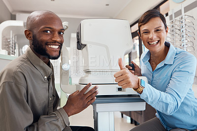 Buy stock photo Eye doctor giving thumbs up after a successful vision test with a happy male patient, portrait. Smiling female optometrist gives a positive gesture after consulting, contact us to find out about us