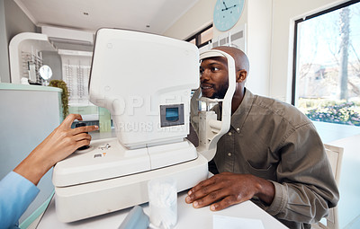 Buy stock photo Eye test, exam or screening with a young man at the optometrist using an automated refractor. Patient testing his vision and eyesight with an optician for prescription glasses or contact lenses