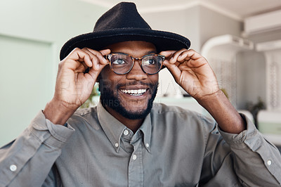 Buy stock photo Trendy, smiling man wearing glasses, buying new eyewear and shopping for new frames at optometrist checkup. Face of a cheerful, cool and stylish male fitting frames at an optician office
