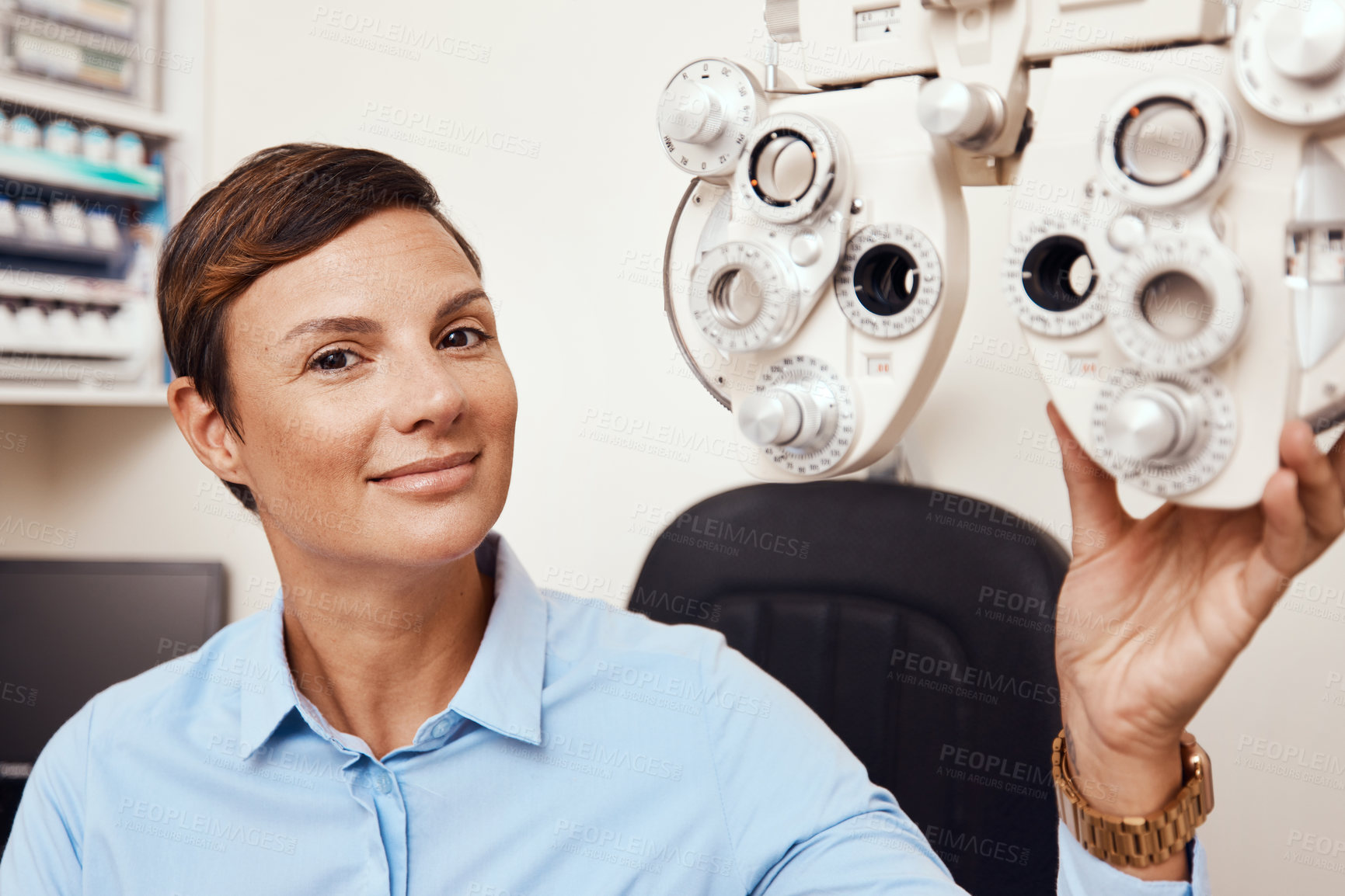 Buy stock photo Portrait of professional optometrist, confident and happy in an optometry office preparing equipment for eye checks. Caucasian female health and ophthalmology expert ready to test a patient