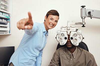 Buy stock photo Happy optometrist doing eye test on a patient, examining vision and doing optical exercise at an optometry checkup. Young black man consulting with an opthalmologist, measuring and checking eyesight