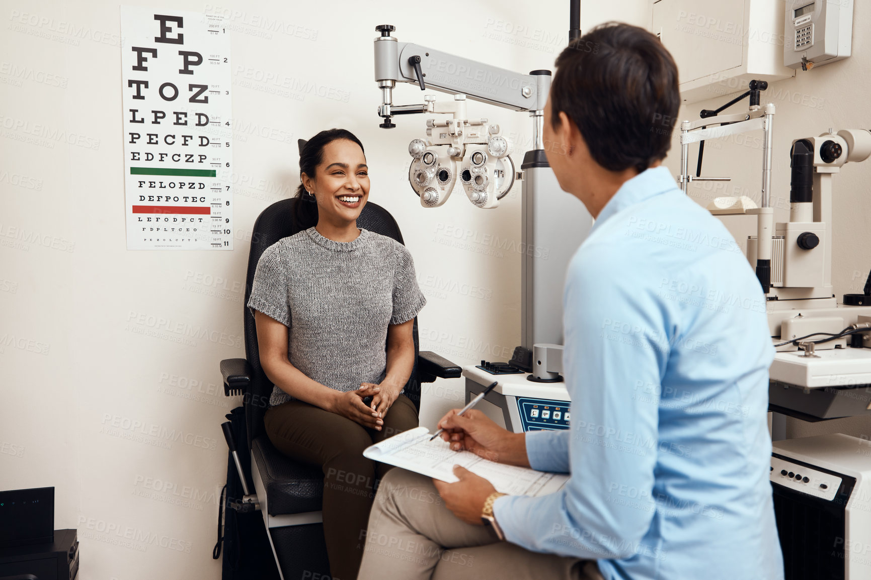 Buy stock photo Shot of a young woman having an eye exam by an optometrist