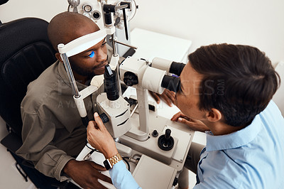 Buy stock photo Eye, vision or sight test or exam of a patient above at an optometrist, optician or ophthalmologist. Testing and checking eyesight on a ophthalmoscope for optical glasses or contact lenses at clinic.