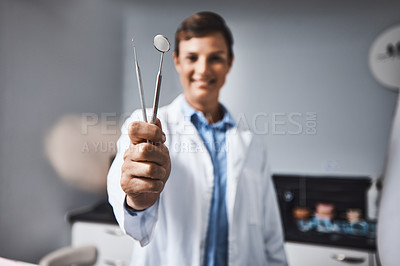 Buy stock photo Portrait of a young woman holding dental tools in her office