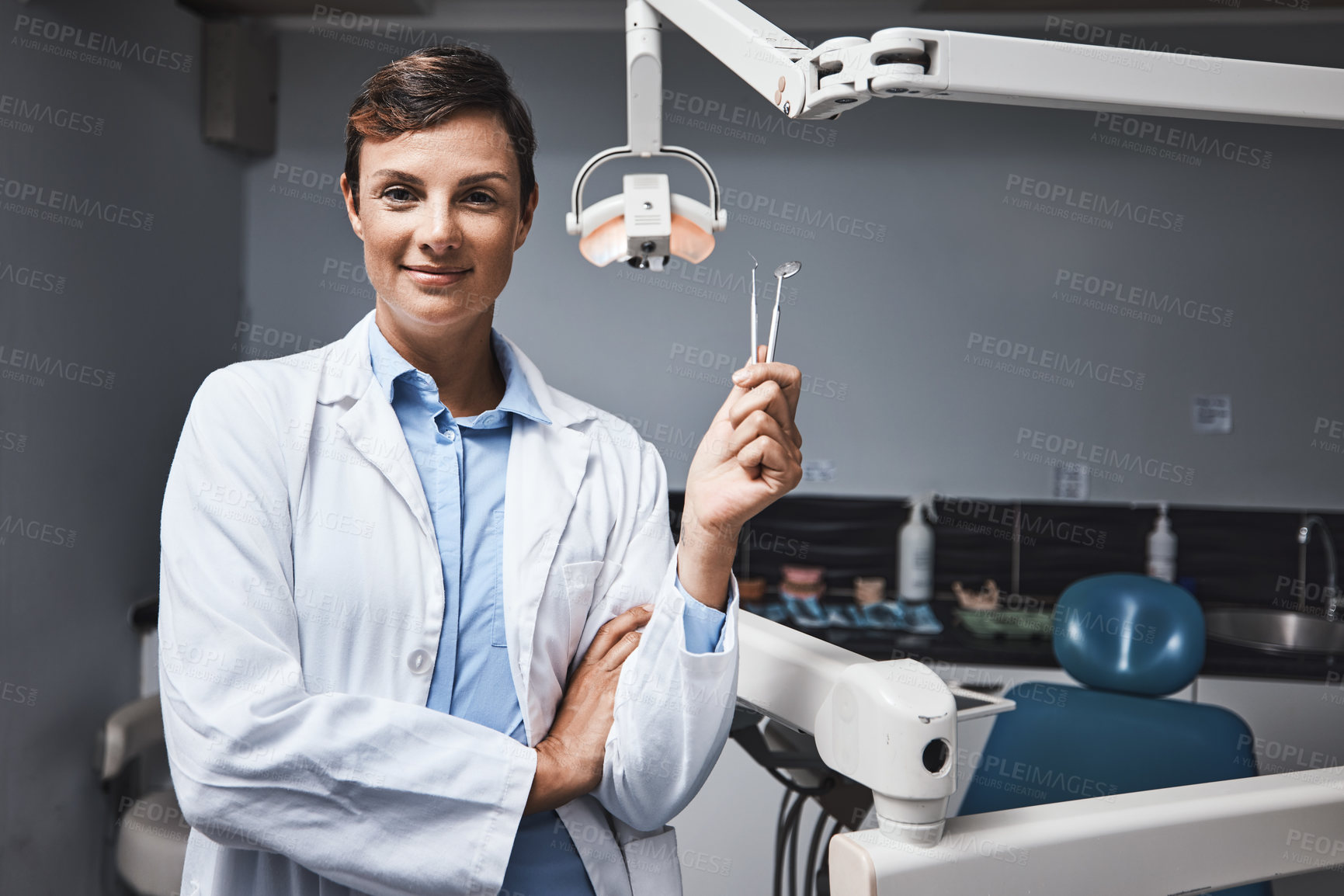 Buy stock photo Portrait of a young woman holding dental tools in her office