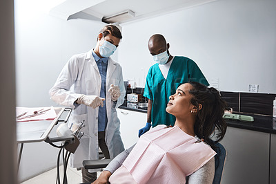 Buy stock photo Shot of a young woman having a consultation with her dentist