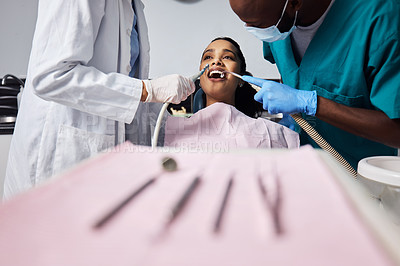 Buy stock photo Shot of a young woman having dental work done on her teeth