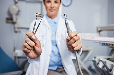 Buy stock photo Portrait of a young woman holding teeth cleaning tools in her dentist’s office
