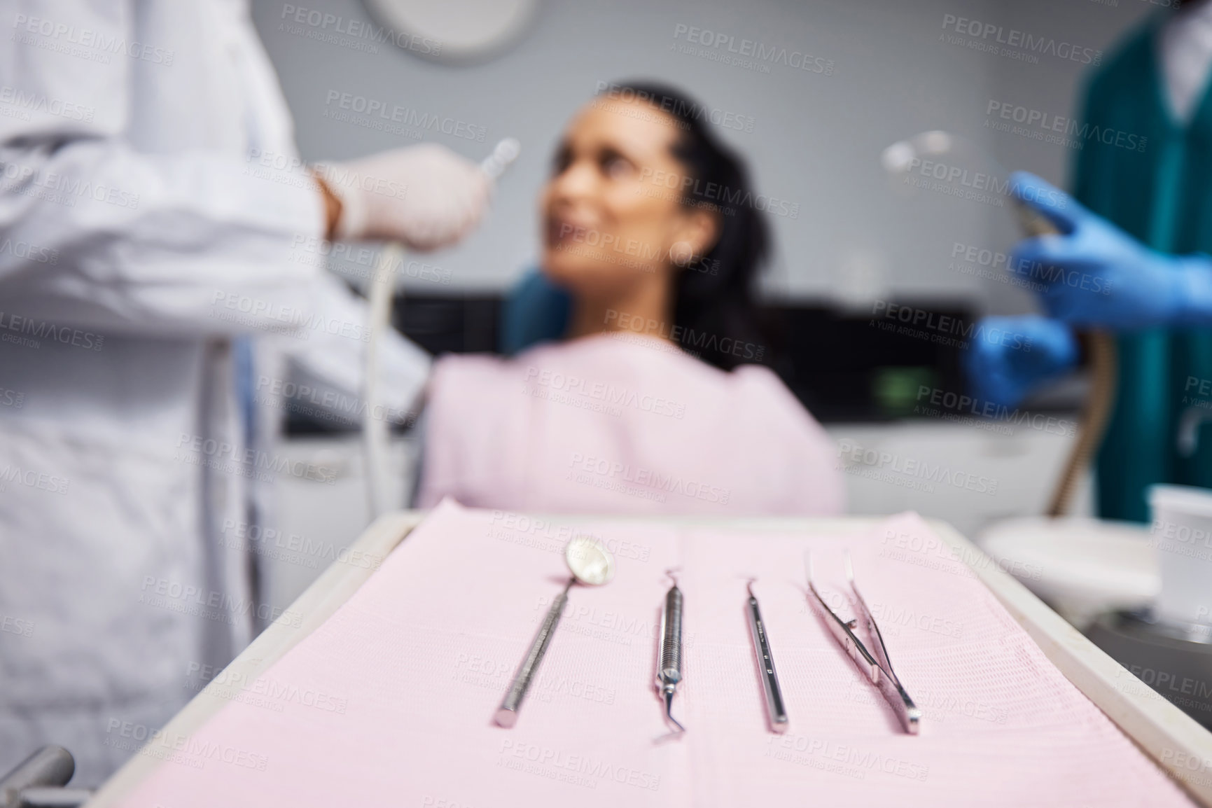 Buy stock photo Shot of a woman having dental work done on her teeth with various tools in the foreground