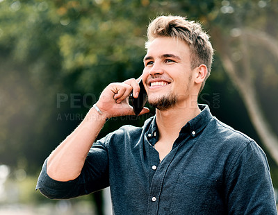 Buy stock photo Cropped portrait shot of a handsome young male student using his mobile phone outside on campus