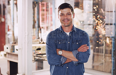 Buy stock photo Cropped shot of a man standing with his arms crossed in his workshop