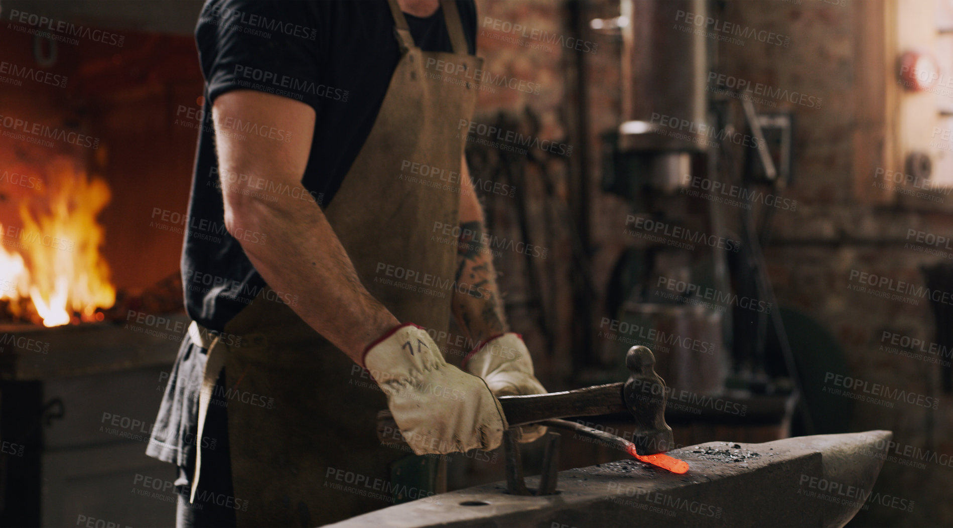 Buy stock photo Blacksmith, man and hands with metal, hammer and flame with equipment for professional craft. Protection, apron and gloves in workshop with anvil for steel, fire and forge for iron product creation