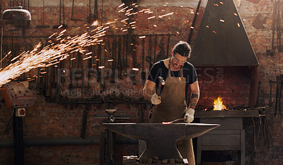 Buy stock photo Hammer, anvil and fire with a man working in a factory for metal work manufacturing or production. Industry, welding and trade with a male blacksmith at work in a forge, plant or industrial workshop