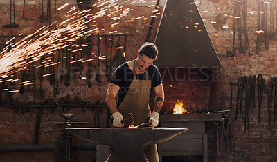 Buy stock photo Hammer, anvil and fire with a man working in a plant for metal work manufacturing or production. Industry, welding and trade with a male blacksmith at work in a factory, forge or industrial workshop