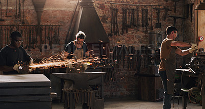 Buy stock photo Hammer, anvil and sparks with a men working in a foundry for metal work manufacturing or production. Industry, welding and trade with a blacksmith people in a workshop, plant or industrial forge