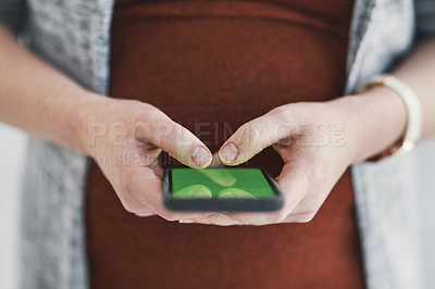 Buy stock photo Shot of an unrecognisable pregnant businesswoman using a smartphone in a modern office
