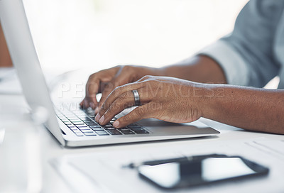 Buy stock photo Shot of an unrecognisable businessman using a laptop in a modern office