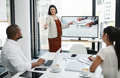 Buy stock photo Shot of a pregnant young businesswoman delivering a presentation to her team in a modern office