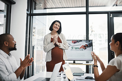 Buy stock photo Shot of a group of businesspeople clapping during a meeting with their pregnant colleague in a modern office