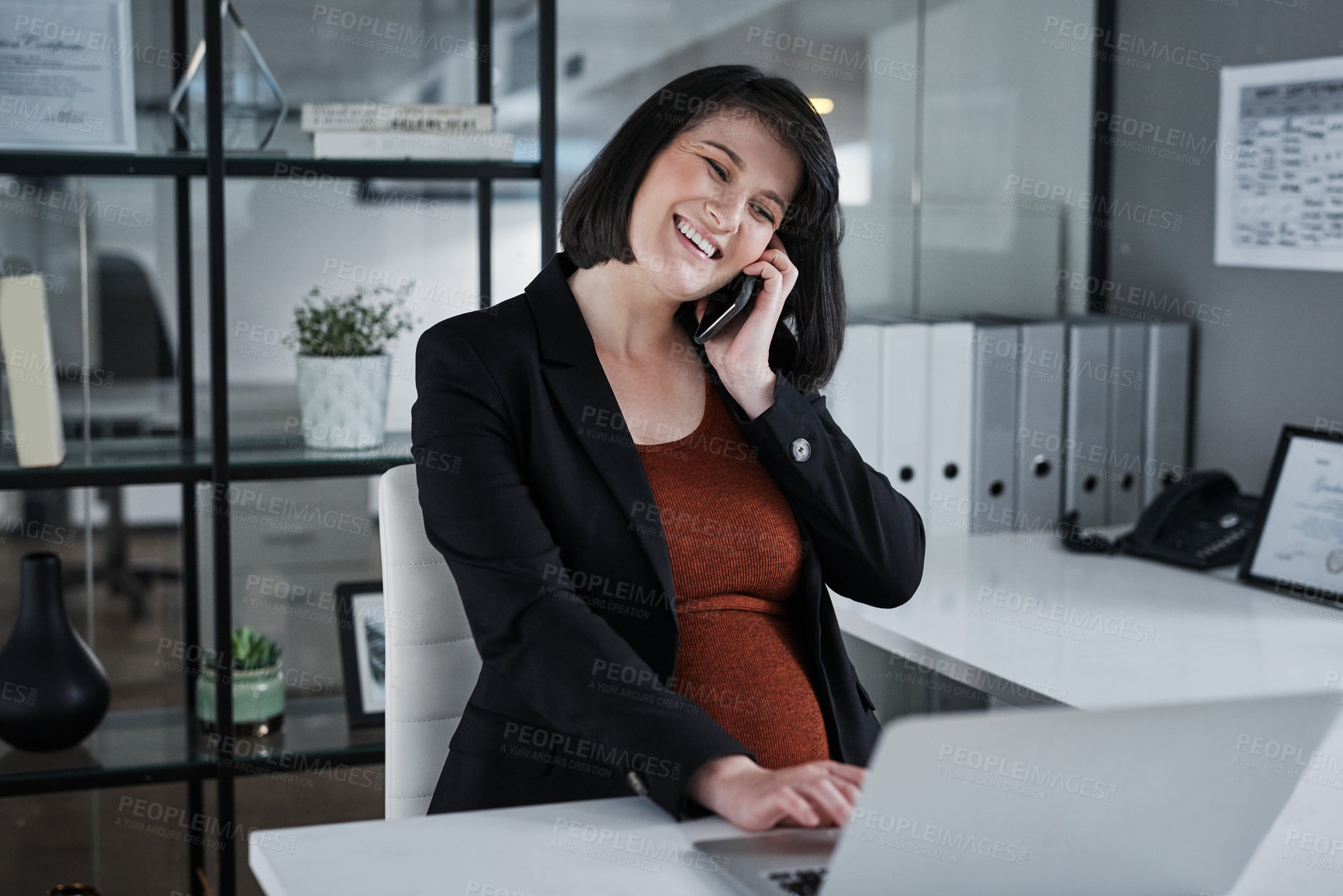 Buy stock photo Cropped shot of an attractive pregnant businesswoman sitting alone in the office and using technology