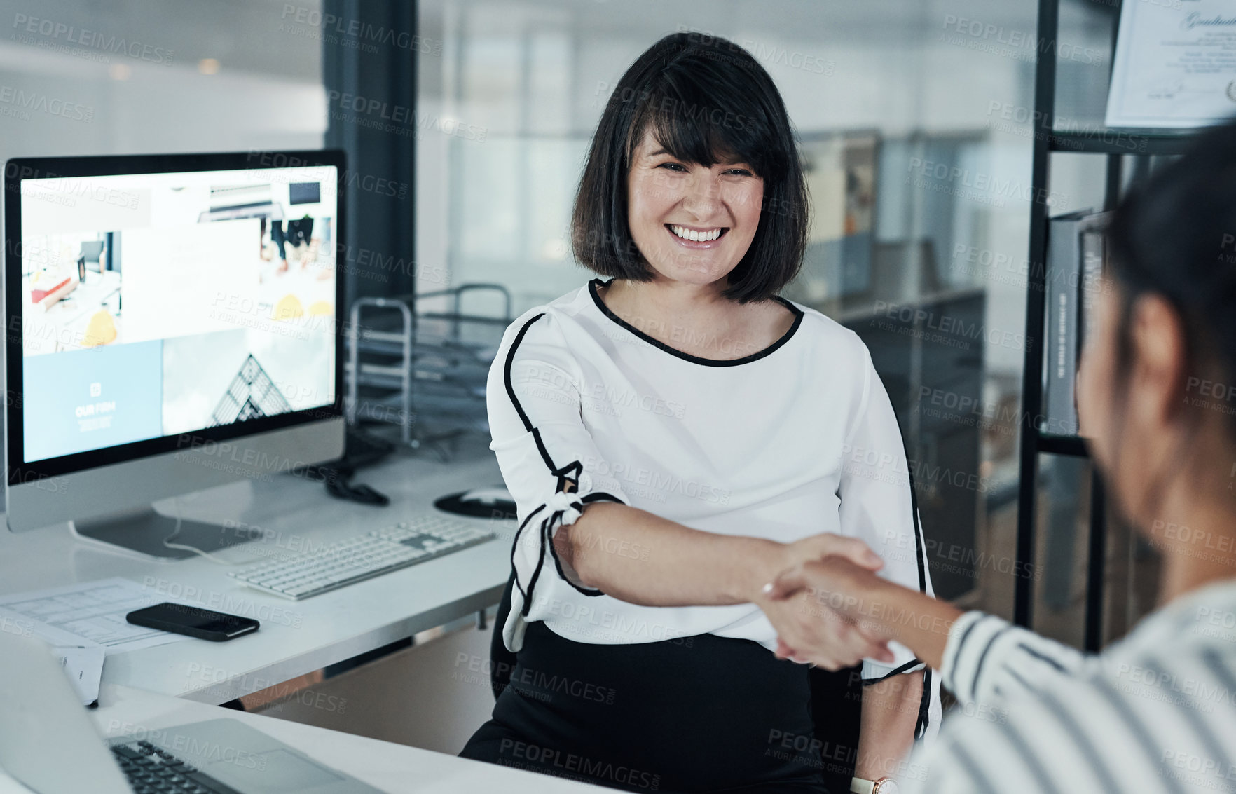 Buy stock photo Cropped shot of an attractive pregnant businesswoman sitting and shaking hands with a colleague in the office