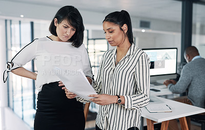 Buy stock photo Cropped shot of young businesspeople standing together and having a discussion in the office