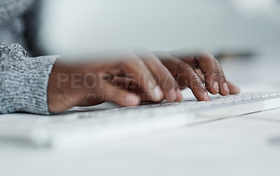 Buy stock photo Cropped shot of an unrecognizable businessman sitting alone in the office and typing on a keyboard