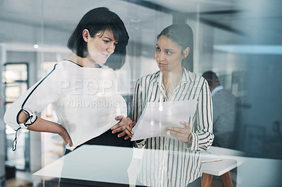 Buy stock photo Cropped shot of young businesspeople standing together and having a discussion in the office