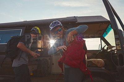 Buy stock photo Shot of two mountain bikers unloading their gear