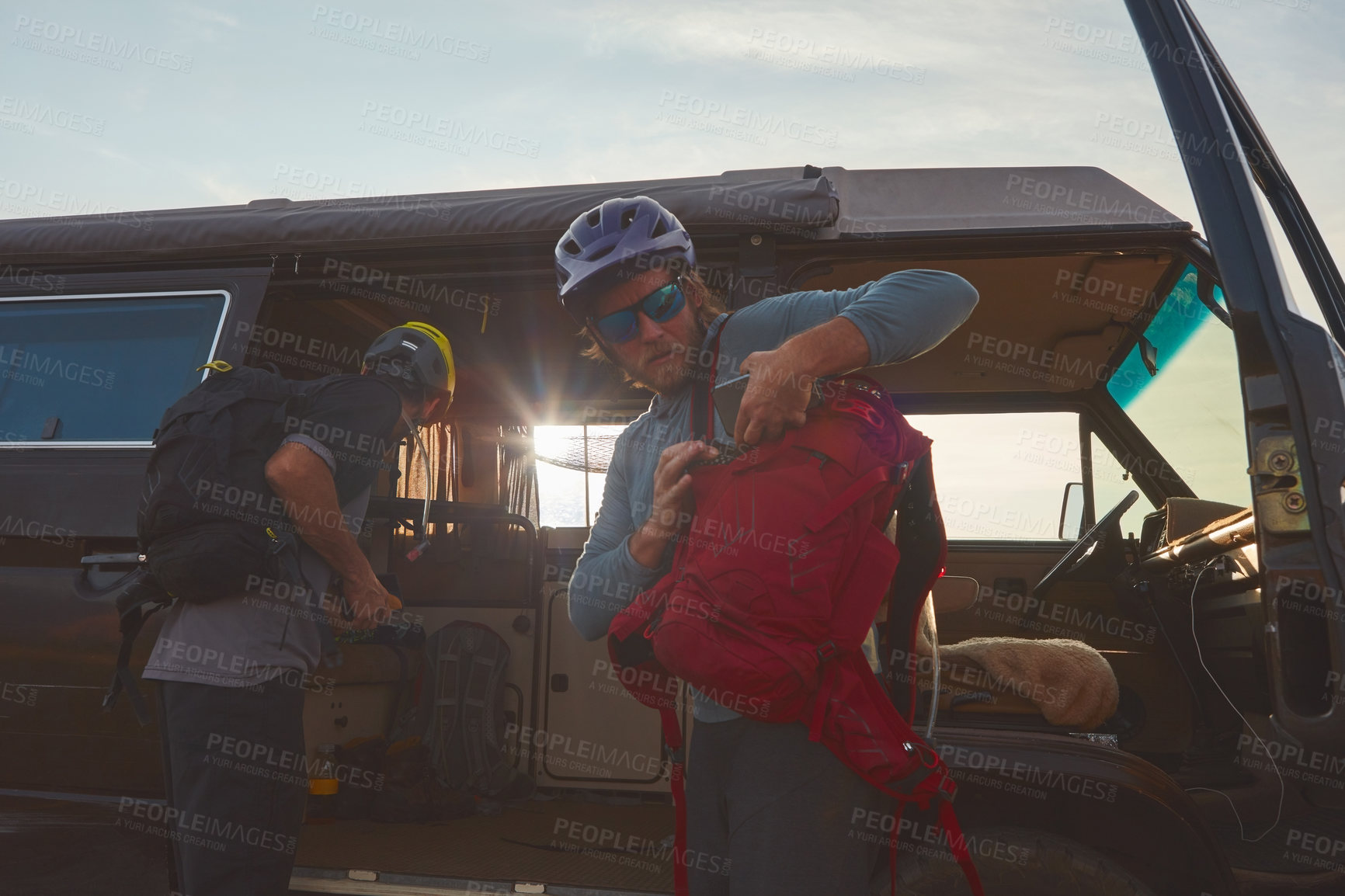 Buy stock photo Shot of two mountain bikers unloading their gear