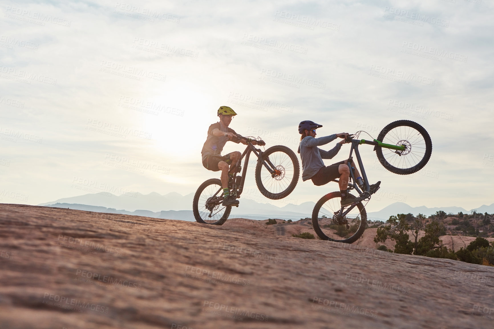 Buy stock photo Full length shot of two men out mountain biking together during the day