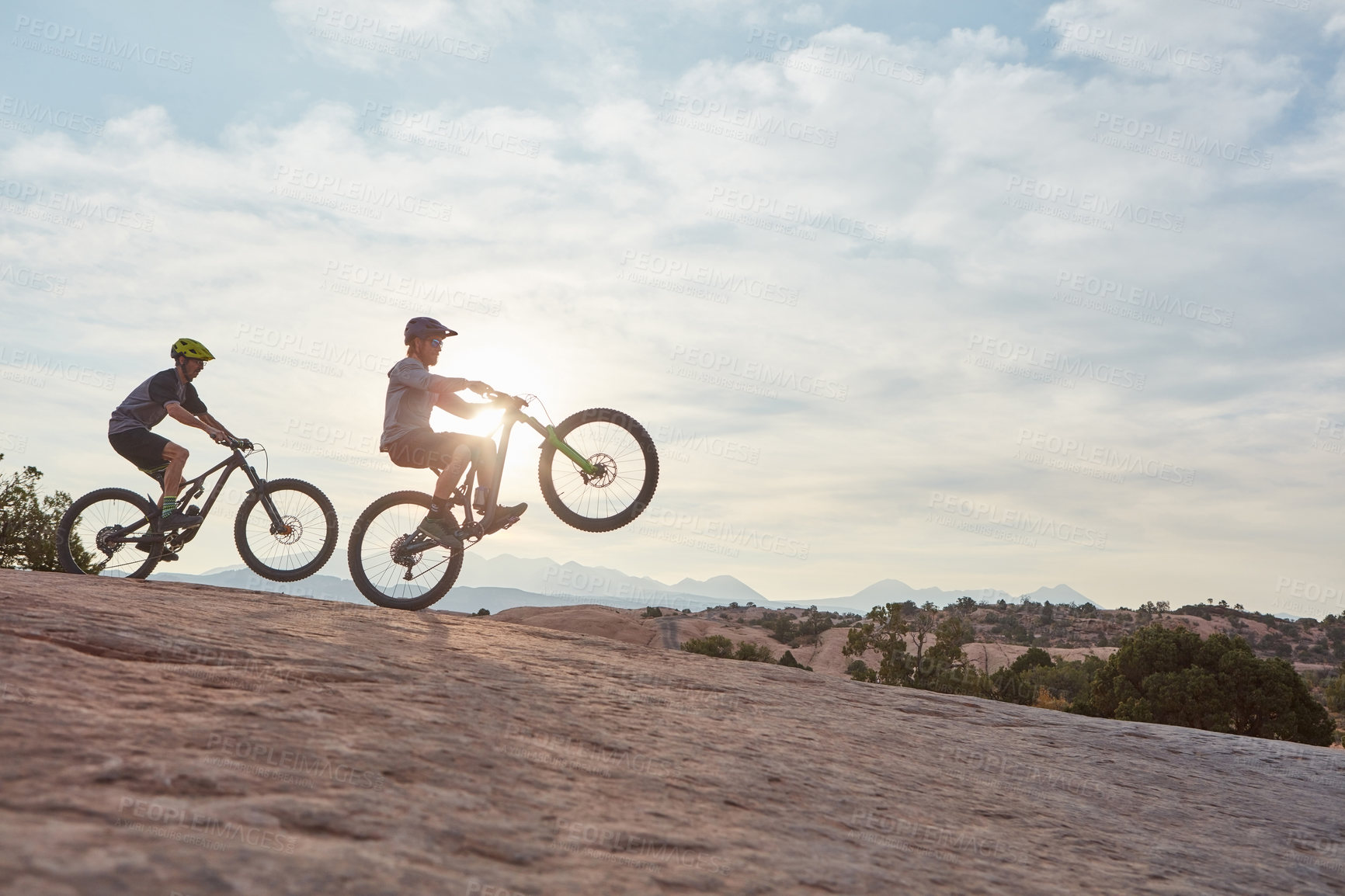 Buy stock photo Full length shot of two men out mountain biking together during the day