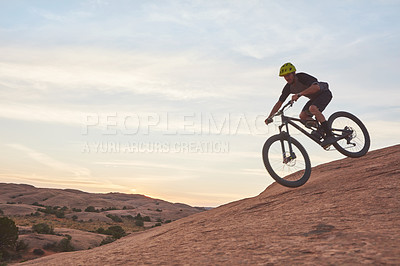 Buy stock photo Shot of a young man out mountain biking during the day