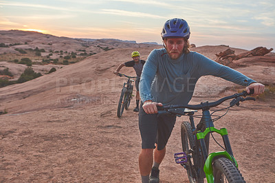 Buy stock photo Full length shot of two men out mountain biking together during the day