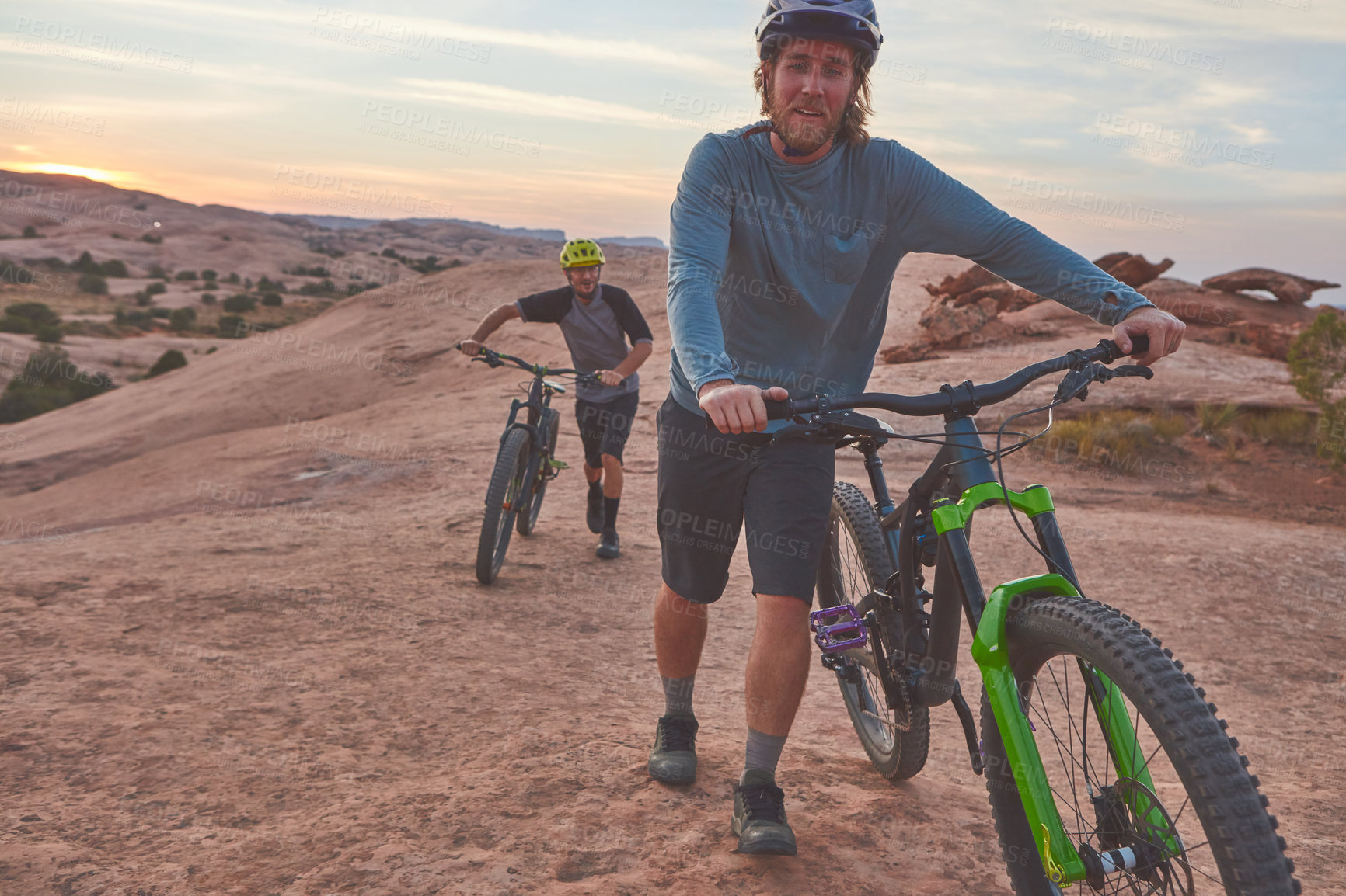 Buy stock photo Full length shot of two men out mountain biking together during the day