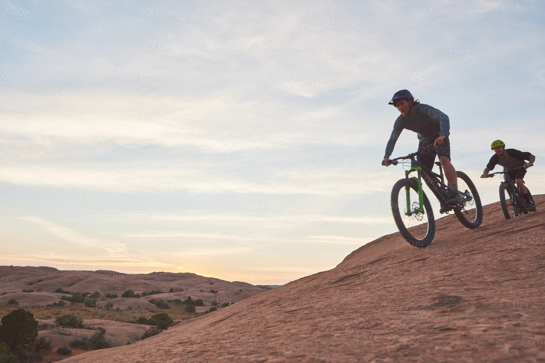 Buy stock photo Full length shot of two men out mountain biking together during the day