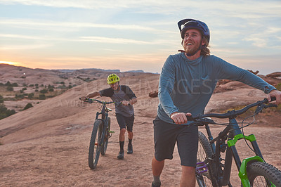 Buy stock photo Full length shot of two men out mountain biking together during the day