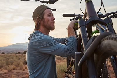 Buy stock photo Shot of a young man out mountain biking during the day