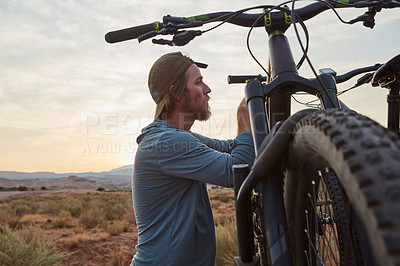 Buy stock photo Shot of a young man out mountain biking during the day