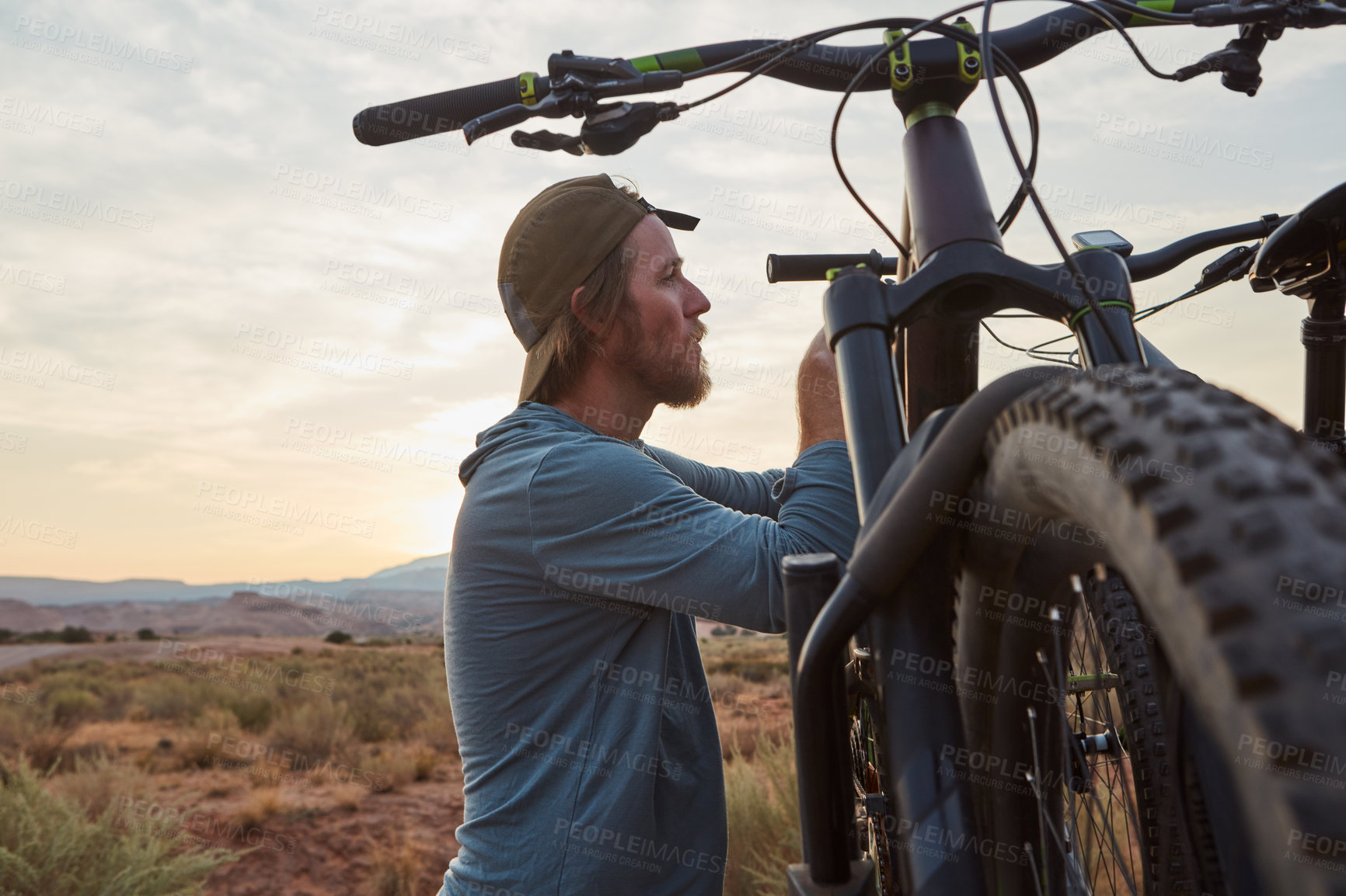 Buy stock photo Shot of a young man out mountain biking during the day