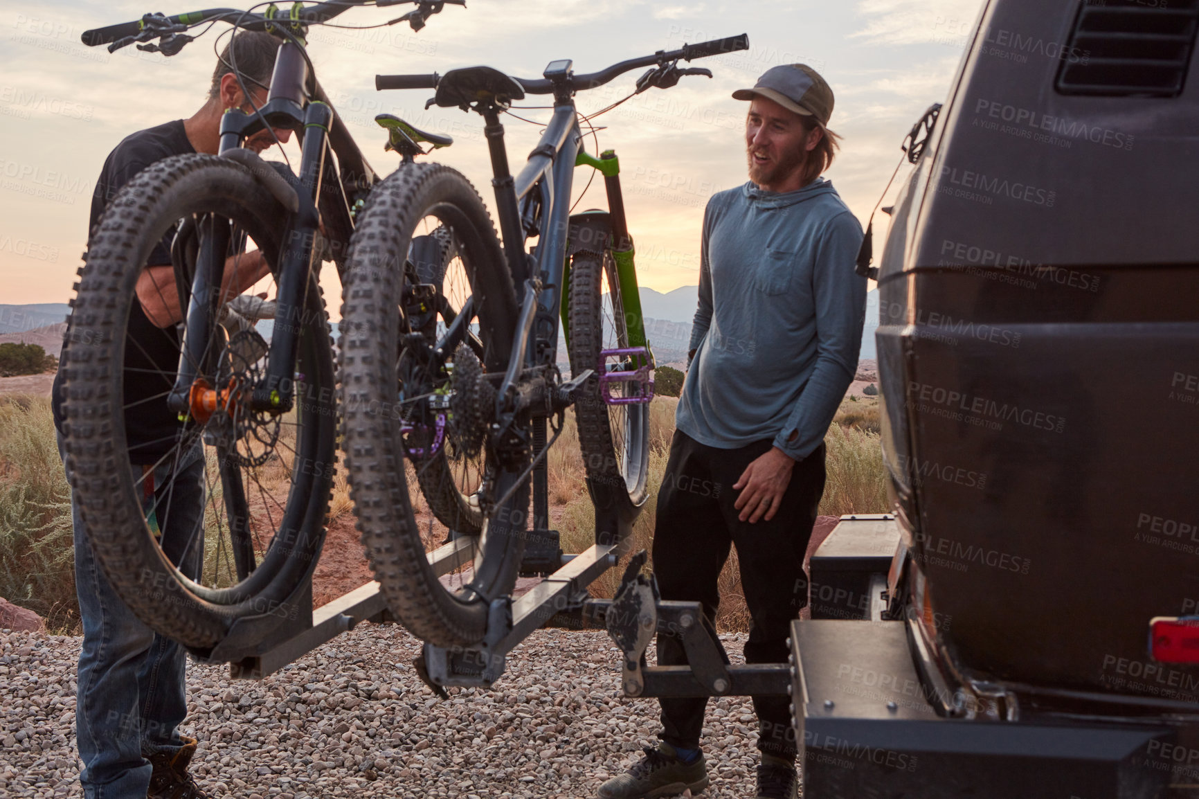 Buy stock photo Shot of two mountain bikers unloading their gear